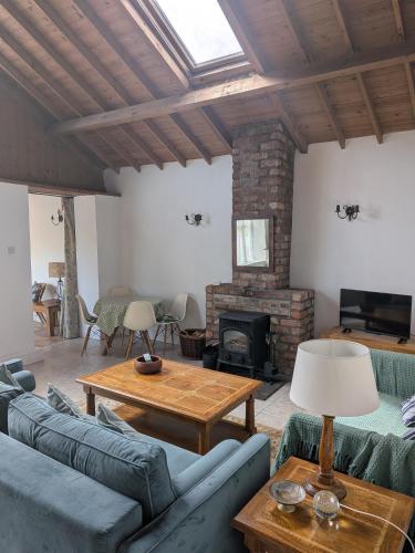 a living room with blue couches and a fireplace at The Stables in Aglish