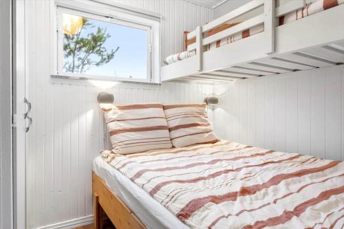 a bedroom with a bed in a room with a window at 1369-Thisted-Nordsovej-94 in Nørre Vorupør
