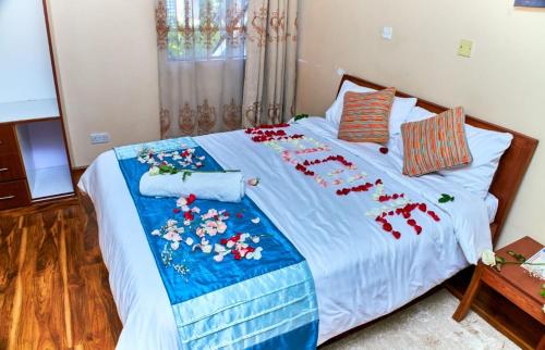 a bedroom with a bed with red decorations on it at Residence Next Door-5 in Nairobi