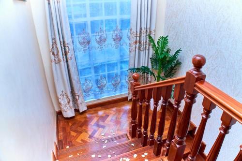 a staircase with a window with a plant next to it at Residence Next Door-5 in Nairobi