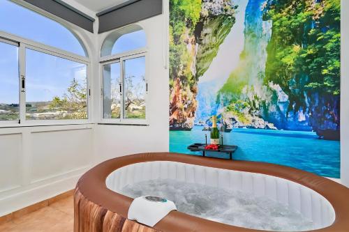 a bathroom with a large painting on the wall at Exclusivo apto. Solparaiso-Jacuzzi in Torrox