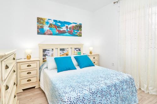 a white bedroom with a bed and a dresser at Exclusivo apto. Solparaiso-Jacuzzi in Torrox