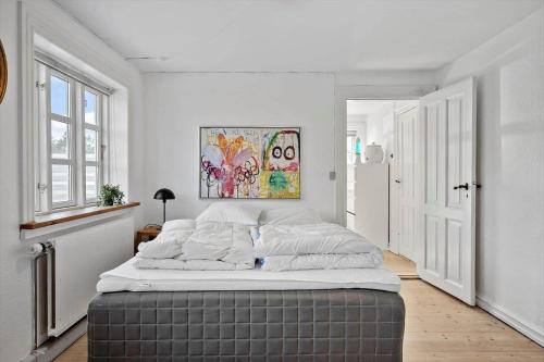 a bedroom with a large bed in a room at 1073-Thisted-Orhagevej-30 in Klitmøller