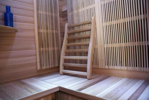 a wooden staircase in a sauna at La Roseraie in Tournai