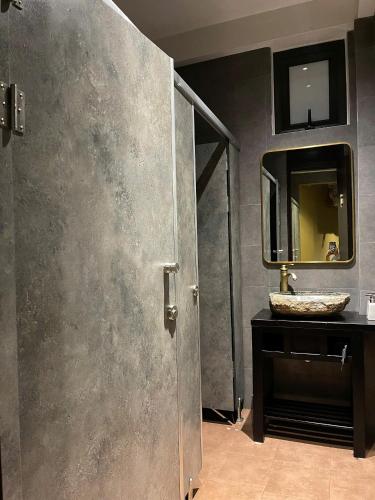 a bathroom with a sink and a mirror at Lavung Village in Ða Gia