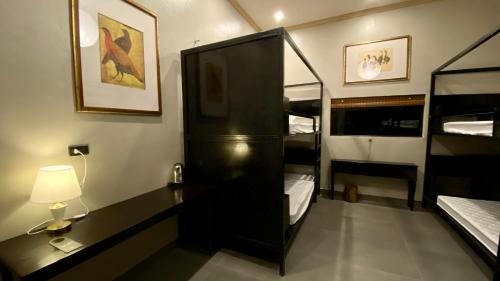 a bedroom with a bunk bed and a desk with a lamp at Lavung Village in Ða Gia