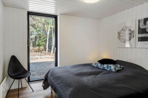 a bedroom with a bed and a large window at 1385-Bedsted-Thy-Nedergardsvej-5 in Istrup