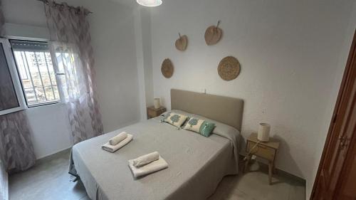 a bedroom with a bed with two towels on it at Toque Andaluz Zarzas in Muntanya la Sella