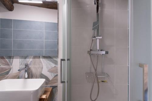 a bathroom with a shower and a white sink at Torre 47 - 49 Rooms in Lamezia Terme