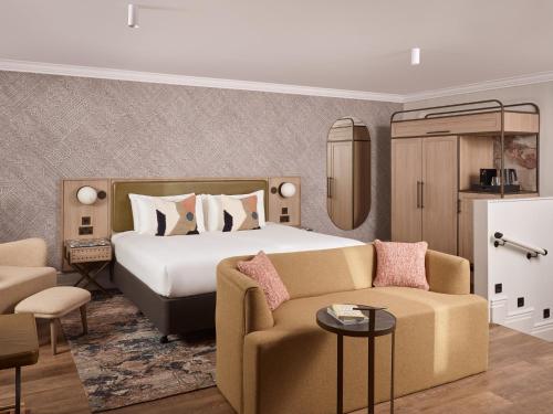 a hotel room with a bed and a couch at The Met Hotel Leeds - Newly Refurbished in Leeds