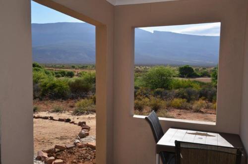 a view from a room with a table and a window at Maskam Guest Farm in Vanrhynsdorp
