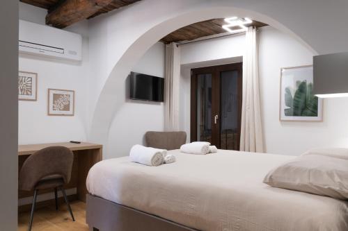 a bedroom with a bed and a desk and a tv at Torre 47 - 49 Rooms in Lamezia Terme