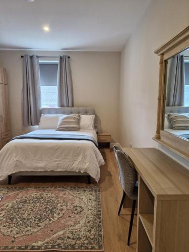 a bedroom with a bed with a desk and a mirror at The old B&B in Killucan