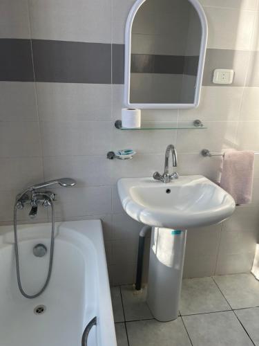 a bathroom with a sink and a bath tub at 3 bedroom Villa with garden in Ez Zahra