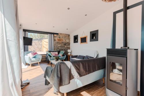 a room with a fireplace and a living room with a couch at La Tour de La Palme in Lapalme
