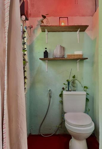 a bathroom with a white toilet in a room at The Artist House in Burgos