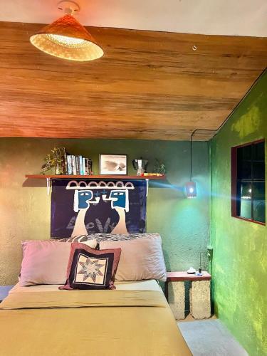 a bedroom with a bed and a green wall at The Artist House in Burgos