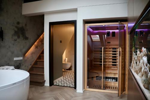 a bathroom with a toilet and a staircase at Bohemia Jacuzzi & Sauna Apartment in Klaipėda