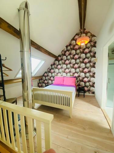a room with a bed in a attic at Au Petit Paradis in Saint-Domet