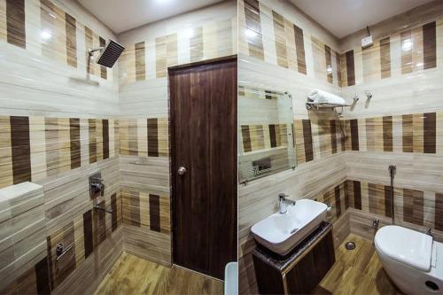 a bathroom with a sink and a toilet in it at Hotel SS Grand in Lucknow