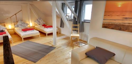 a living room with two beds and a couch at Apartment Mammut Loft in Balve