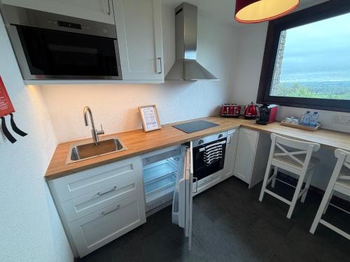 a kitchen with a sink and a counter with a window at Tullyeskar House - Monasterboice in Philipstown