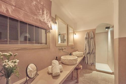 a bathroom with a sink and a toilet and a mirror at Casa penisula in Porto-Vecchio