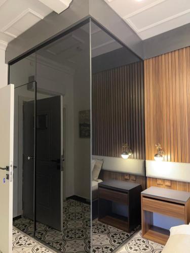 a room with a mirror and a bed and a table at Şah Bey Konağı in Istanbul