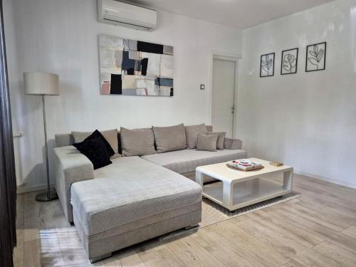 a living room with a couch and a coffee table at Apartman Franko - SELF CHECK IN in Osijek