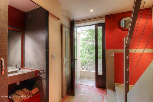a bathroom with a sink and a shower and a mirror at Couvent d'alando in Alando