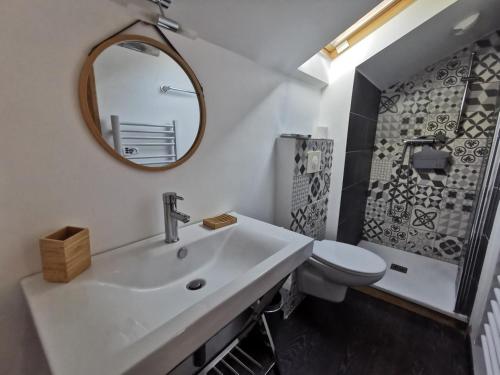 a white bathroom with a sink and a mirror at Casa di l'apa in Venaco