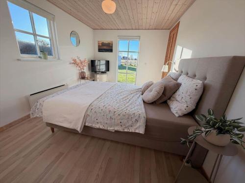 a bedroom with a large bed and a window at 7000-Bogo-By-Mosedalen-6 in Bogø By