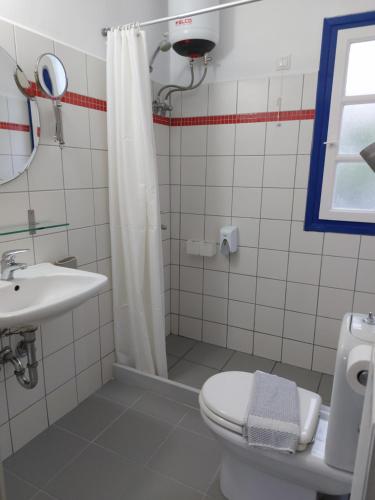 a bathroom with a toilet and a sink and a shower at Kyfanta, studios & apartments in Kyparissi in Kiparission