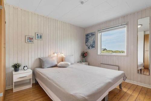 a bedroom with a large bed and a window at OH412-Hadsund-Halvrebene-94 in Hadsund