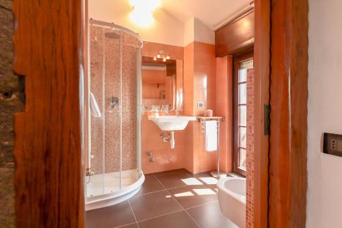 a bathroom with a shower and a sink and a tub at Zavaglia House in Lainate