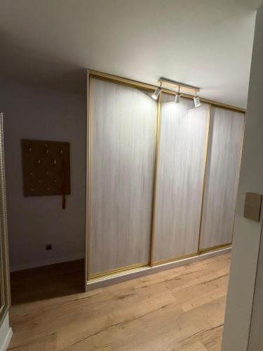 a room with sliding doors on the wall at Anuszka Apartament 3 in Gdynia