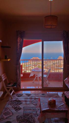 a living room with a view of a balcony at Chalet in Porto Sokhna Hanging Gardens - Fifth Terrace Sea View شاليه في بورتو السخنة - الحدائق المعلقة - المصطبة الخامسة - إطلالة بحر مباشر in Ain Sokhna