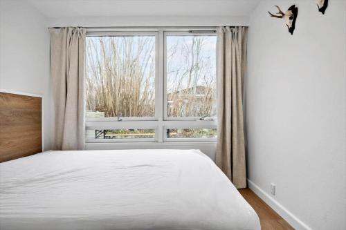 a bedroom with a bed and a large window at S754-Stroby-Ladeplads-Svalemosevej-84 in Strøby Ladeplads