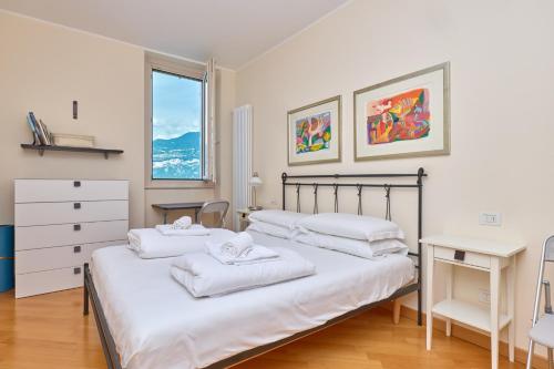 a bedroom with two beds and a desk at The Lake Balcony by Gardenjoy in Brenzone sul Garda
