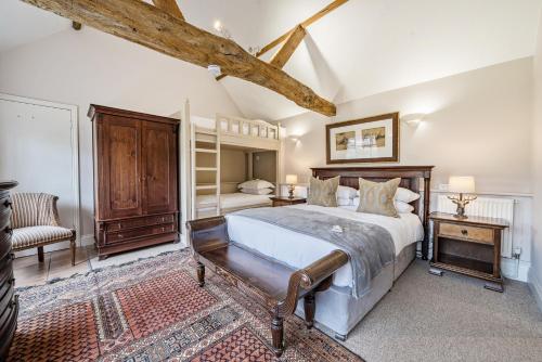 a bedroom with a bed and a desk and a chair at Luxury Cottage & Spa in Guildford