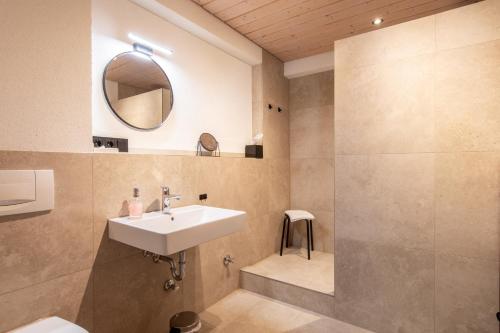 a bathroom with a sink and a mirror at Gästehaus Kaltenbach in Staufen im Breisgau