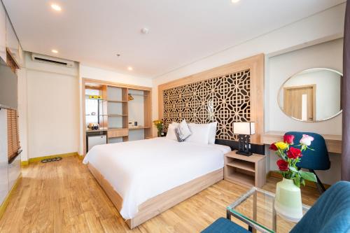 a bedroom with a white bed and a mirror at Gemini Saigon LUXURY in Ho Chi Minh City