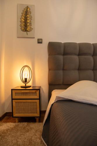 a bedroom with a bed and a table with a mirror at family home in Dimitsana