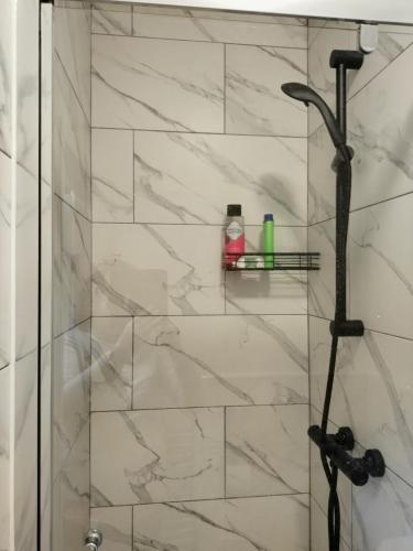 a bathroom with a shower with a glass door at Cornerstone Budget in Ashford