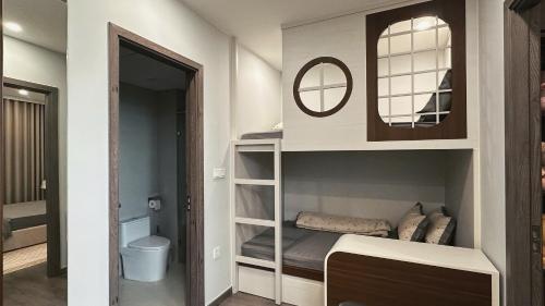 a small bedroom with a bunk bed and a mirror at Ruby's Home The Ruby Hạ Long in Ha Long
