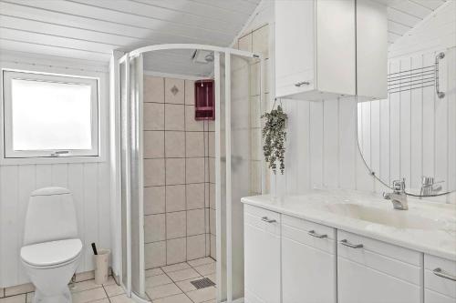 a white bathroom with a toilet and a sink at OH496-Hadsund-Kaeragervej-12 in Hadsund