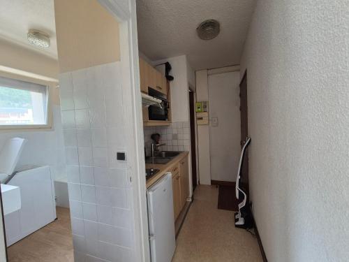 a small kitchen with a sink and a counter at Studio centre Bourg-Saint-Maurice in Bourg-Saint-Maurice