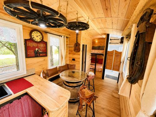 a dining room and living room of a tiny house at Roulotte Cowboy - Tiny House insolite in Mignaloux-Beauvoir