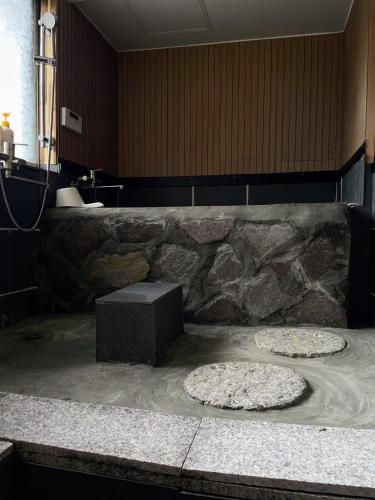 two pizzas sitting on the floor in a bathroom at 癒しの宿鎌野 in Takamatsu