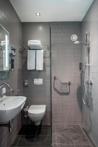 a bathroom with a toilet and a sink and a shower at Hotel Mansion in Amsterdam